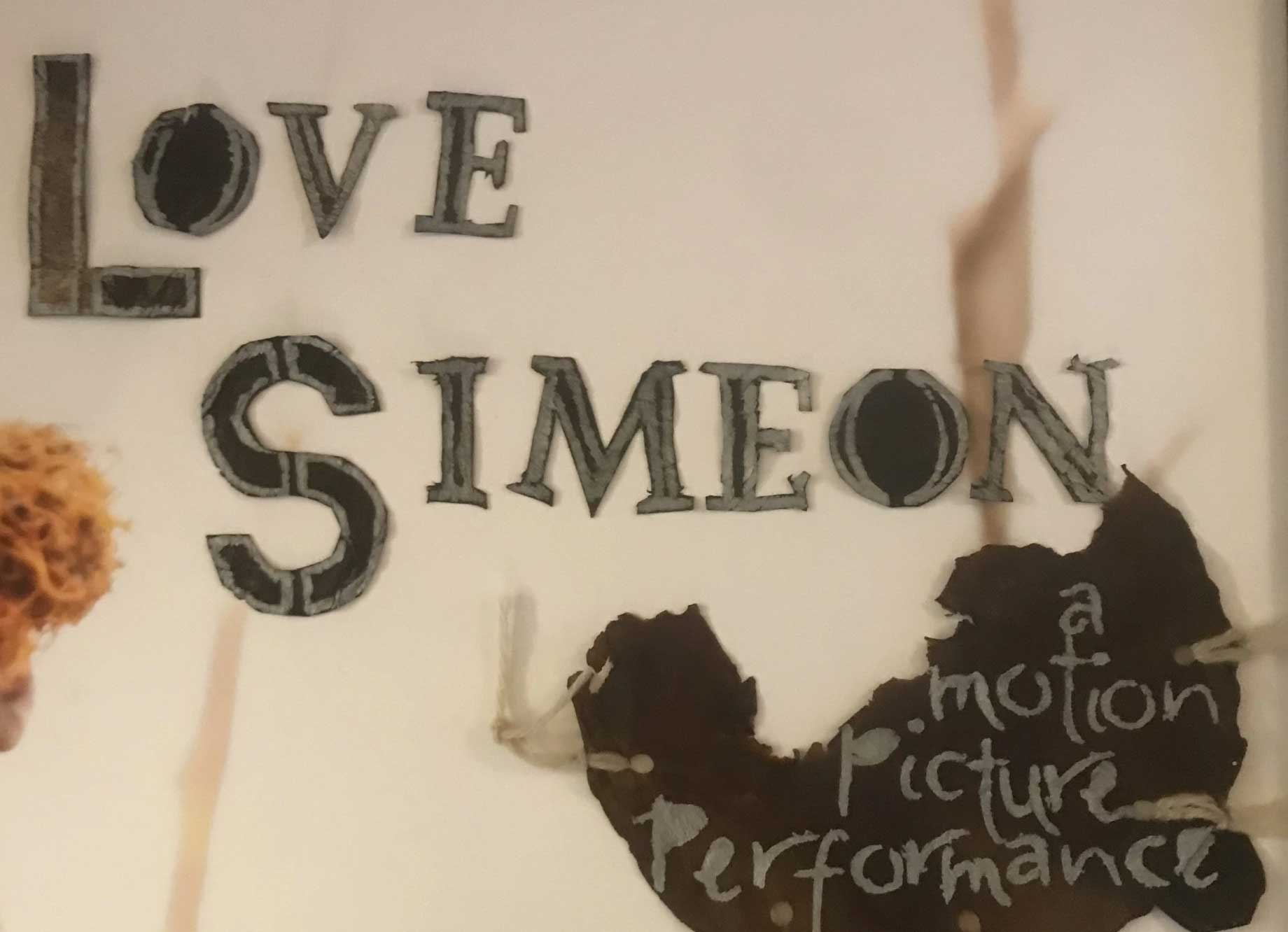 Torn paper image with the words "Love, Simeon - a motion picture performance" in charmingly handmade lettering.