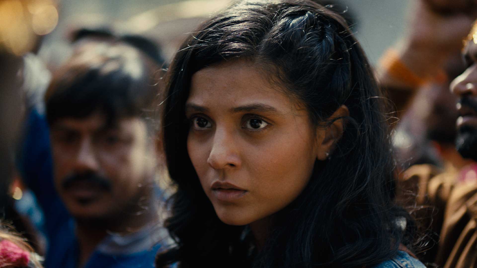 Pinch_websize A closeup of a young, striking South Asian girl who has a poignantly distressed expression on her face.